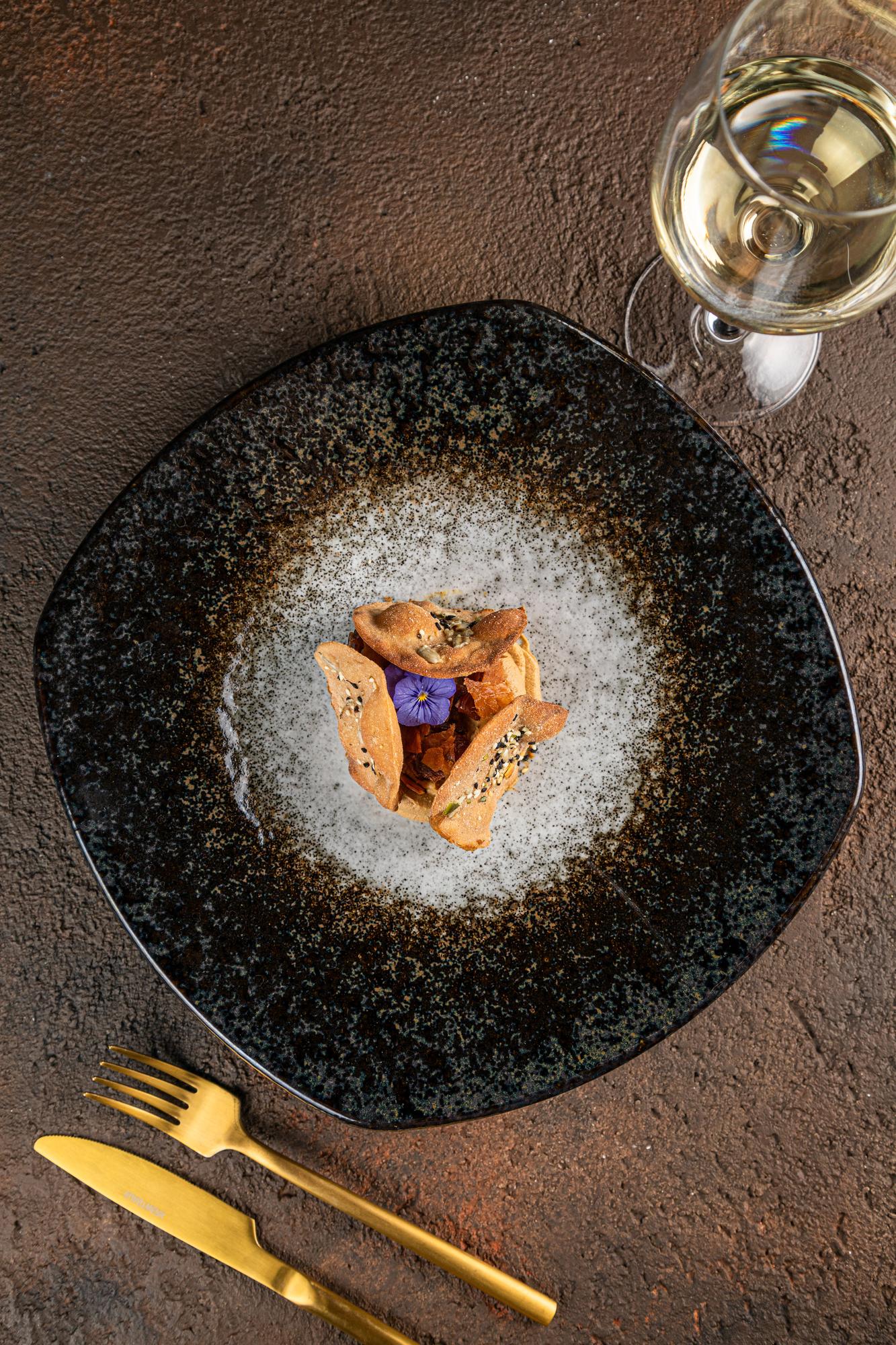 Large editorial shot of plated dessert with gold leaf